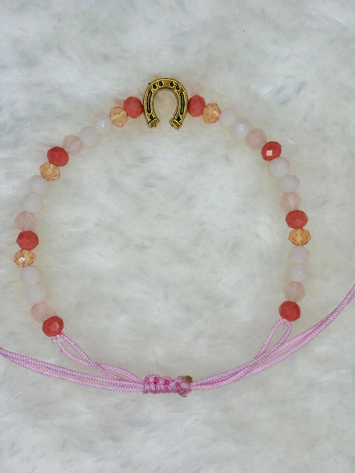 PULSERA MARONA CON HERRADURA DORADA ROSA