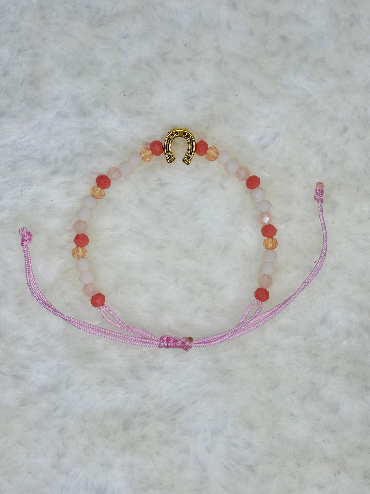 PULSERA MARONA CON HERRADURA DORADA ROSA