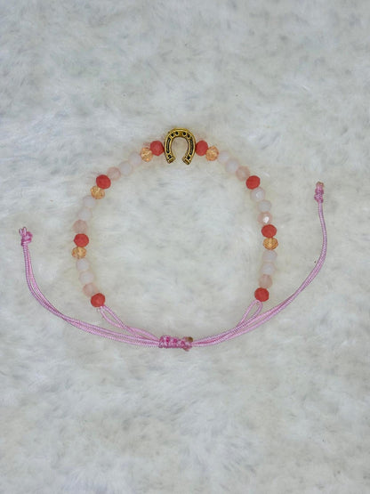 PULSERA MARONA CON HERRADURA DORADA ROSA