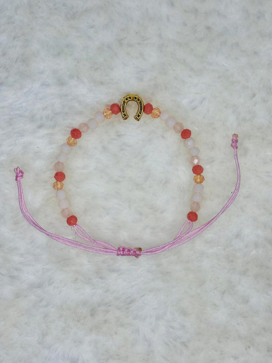 PULSERA MARONA CON HERRADURA DORADA ROSA